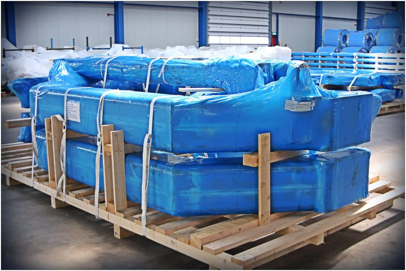 Machine components packed in protective wooden crates at the terminal
